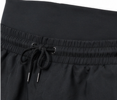 Close-up of high-waisted swim shorts waistband and drawstring